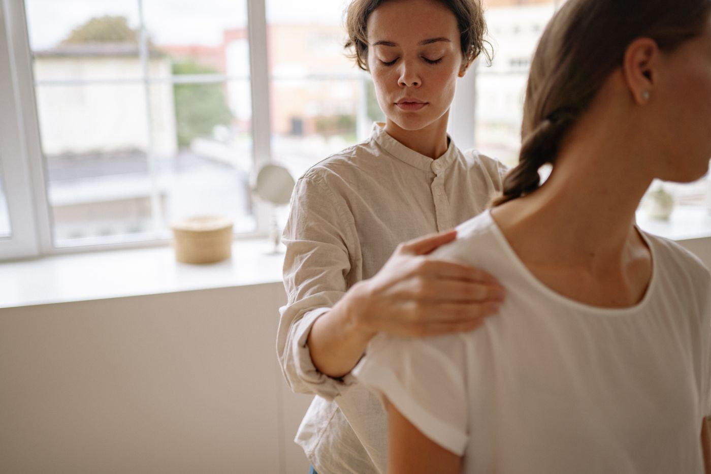 Physiotherapist assisting a patient with a home rehabilitation session